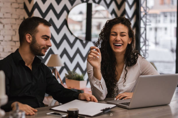 istock Beautiful loving couple smiling in a cafe, working together. 882319304