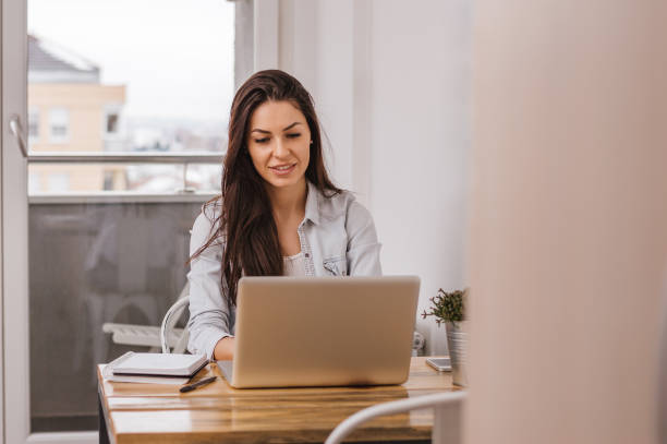 istock Beautiful girl working on computer at home 882319352
