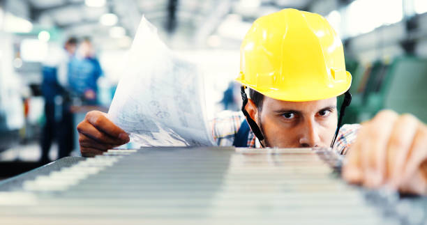 istock Industry Worker entering data in CNC machine at factory 882322338