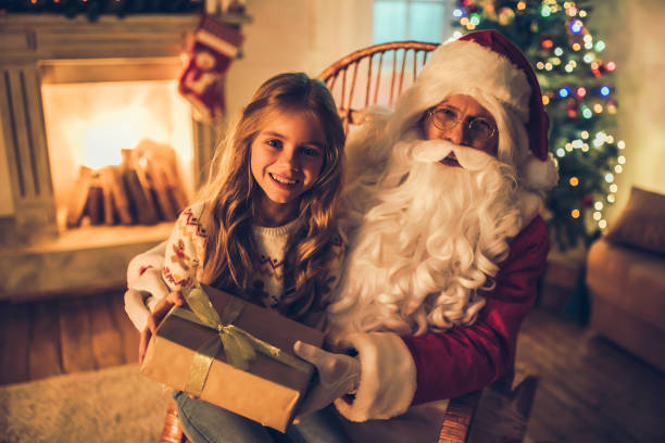 istock Girl with Santa Claus. 882323216