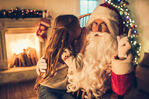 istock Girl with Santa Claus. 882323318
