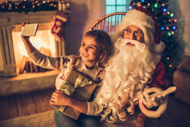 istock Girl with Santa Claus. 882323394