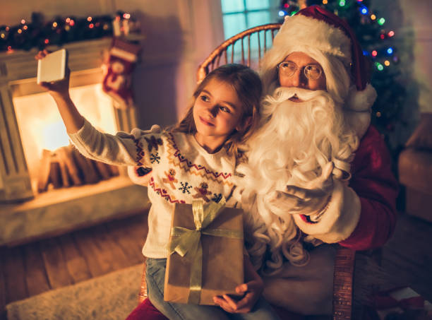 istock Girl with Santa Claus. 882323434