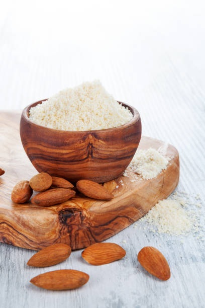Bowl of almond flour with almonds stock photo