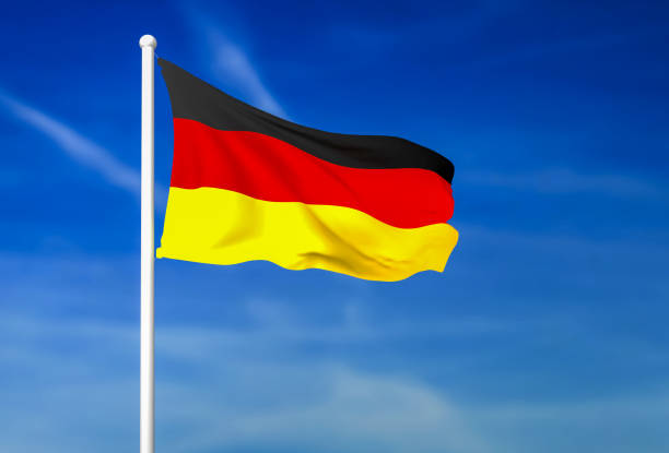 istock Waving flag of Germany on the blue sky background 882326438