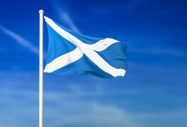 Waving flag of Scotland on the blue sky background stock photo