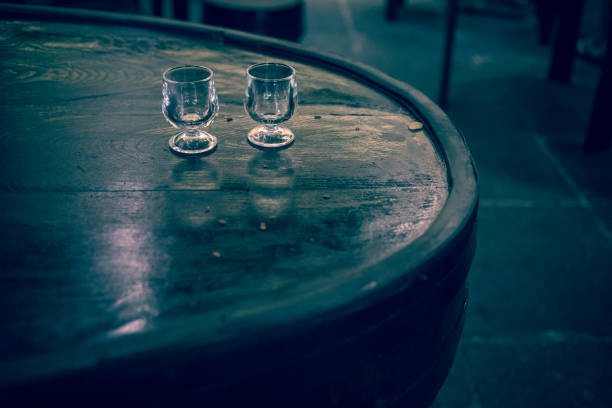 small empty glasses left on the old wooden table after tasting of Madeira wine.