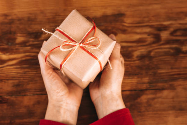istock Woman hands holding Christmas Present 882327144