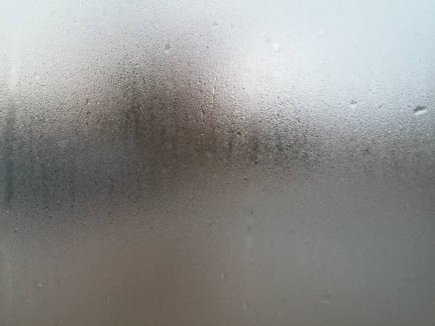 istock water on a flat surface of glass, abstract texture 882327524