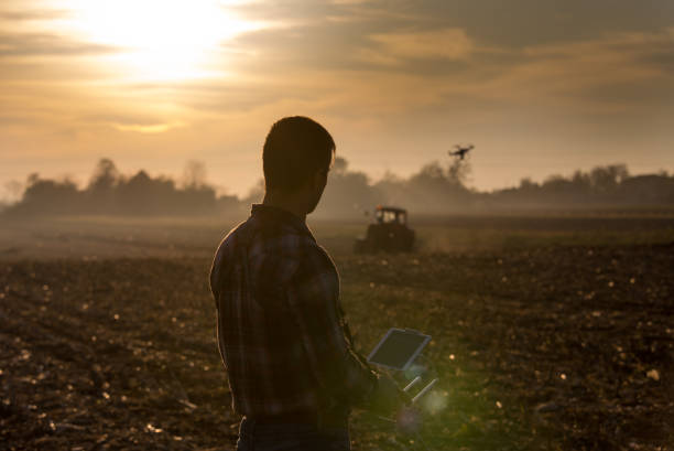 istock Farmer navigating drone above farmland 882329904