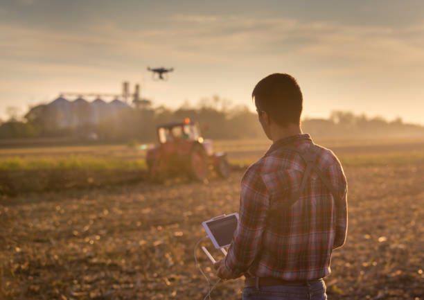 istock Farmer navigating drone above farmland 882330172