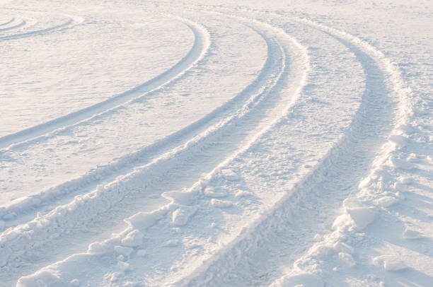 istock Car tire tracks in fresh snow 882330312