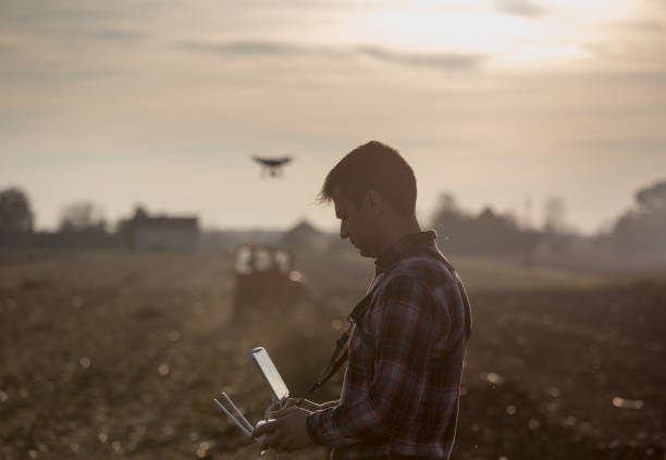 istock Farmer navigating drone above farmland 882330370