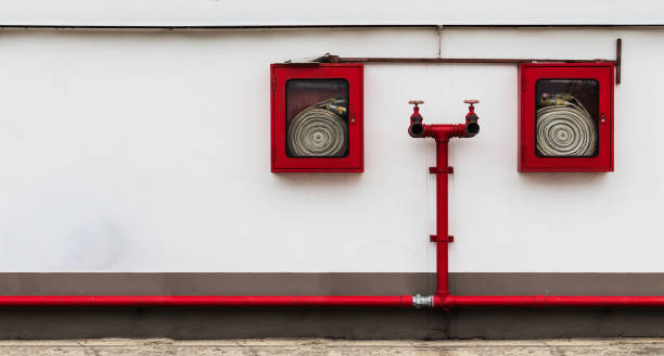 istock fire hose cabinet on the white wall with many copy space 882331368
