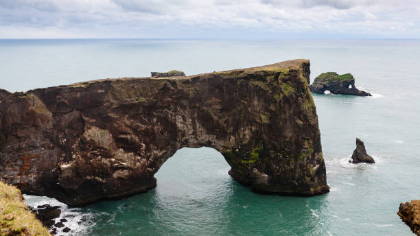istock view stone arch on Dyrholaey peninsula in Iceland 882331476