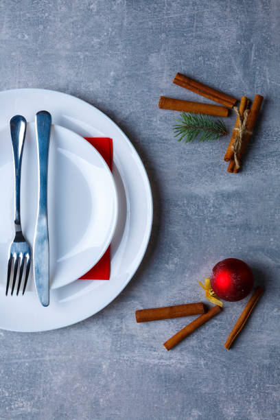 istock A plate in the plate is shown not completely with a fork and knife turned down on a stone background. View from above 882334074