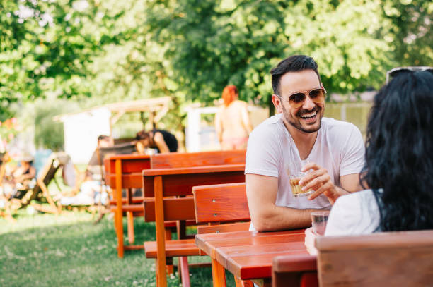 istock Young couple talking at coffee shop on a date 882337060
