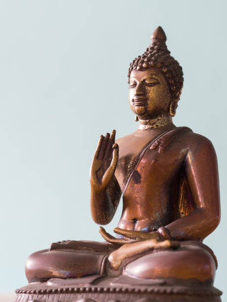 istock Antique Buddha Statue with Clipping Path. The background is Periwinkle Gray(isolated) 882340834