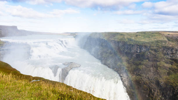 istock view of rainbow in water spray over waterfall 882349412