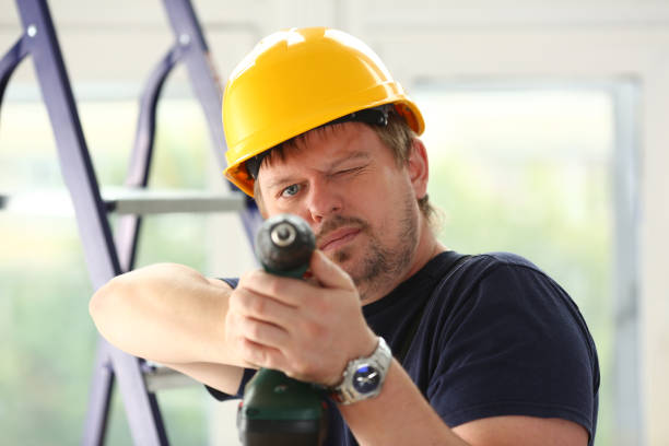 istock Arms of worker using electric drill closeup 882350324