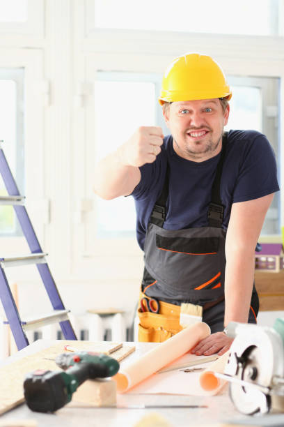 istock Smiling funny worker in yellow helmet 882350378