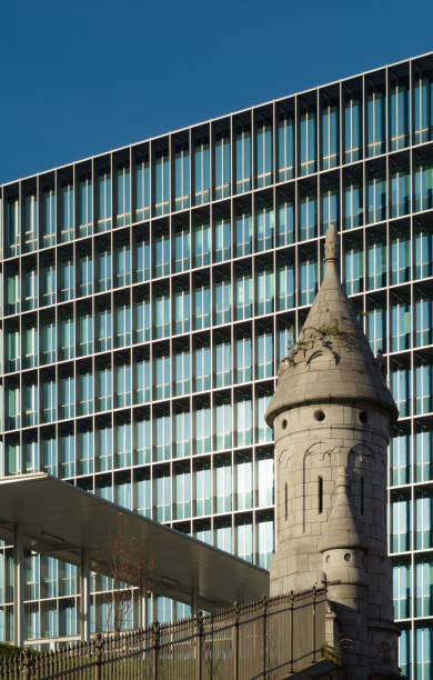 Modern building behind old railway track tower in Antwerp