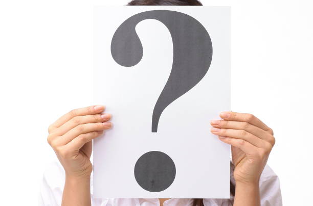 istock closeup.young woman showing a question mark 882351106