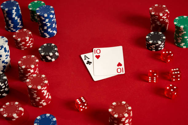istock Poker cards and gambling chips on red background 882354038