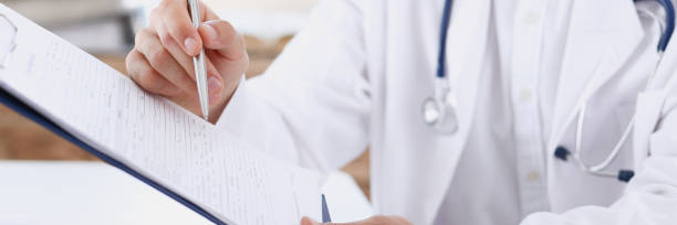 istock Male doctor hand hold silver pen and 882358034