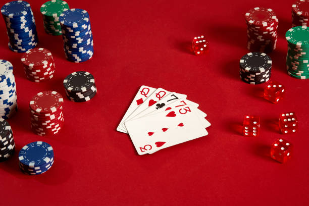 istock Poker cards and gambling chips on red background 882358520