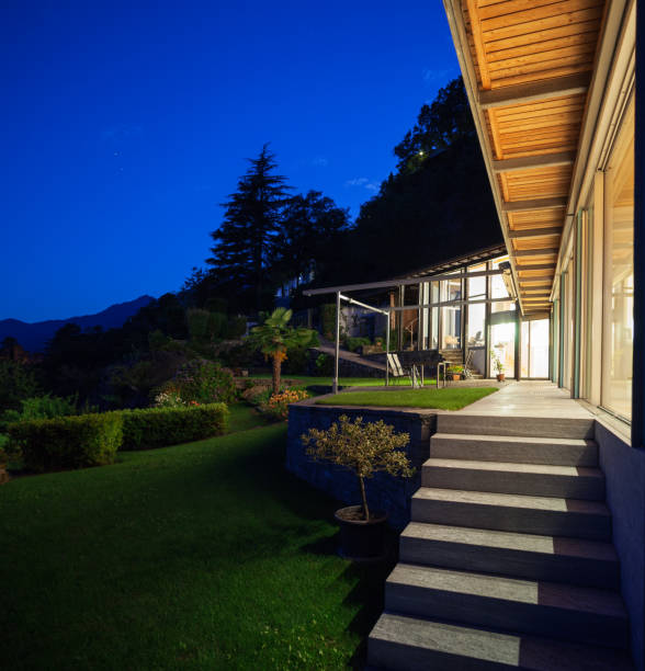 Night landscape with alight villa, steps and veranda