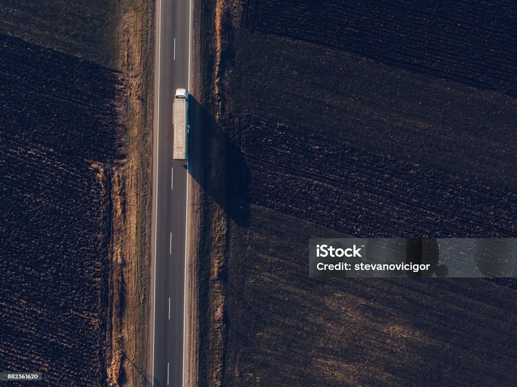 Aerial view of freight transportation truck Aerial view of freight transportation truck on the road through countryside Truck Stock Photo