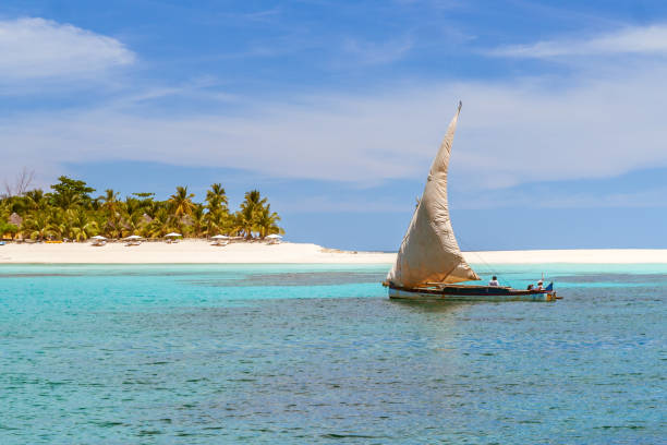 Nosy Iranja, Madagascar Nosy Iranja, Madagascar, April 5, 2017: A fishing dugout canoe passing in front of Nosy Iranja island near Nosy Be in the North West of Madagascar madagascar beach photos stock pictures, royalty-free photos & images