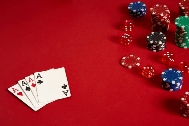 istock Poker cards and gambling chips on red background 882367692