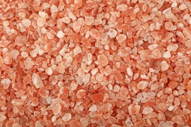 istock Close up background of pink Himalayan salt 882368284