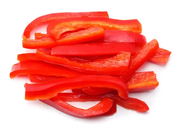 cut slices of red sweet bell pepper isolated on white background