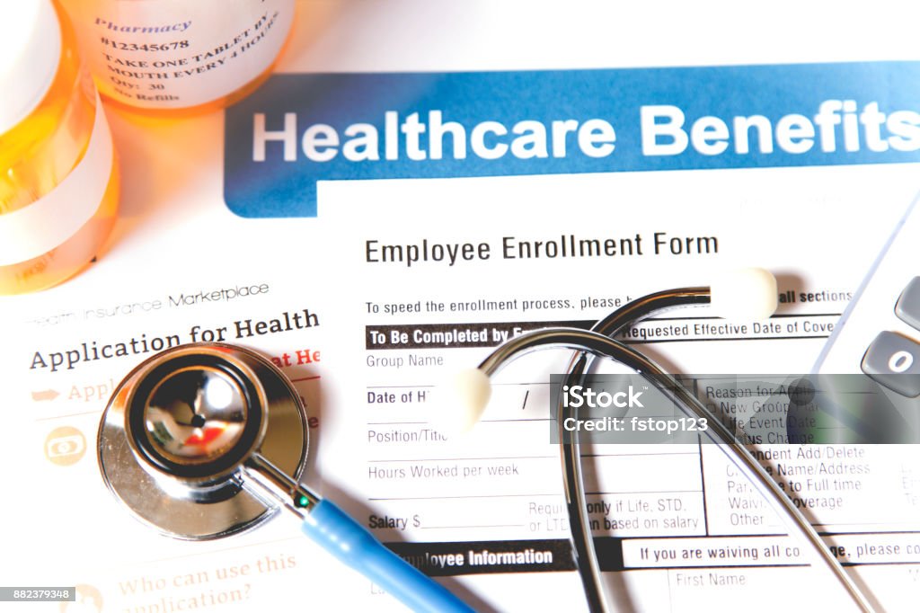 Open enrollment healthcare benefit forms. Healthcare benefit forms including: enrollment forms and applications, stethoscope, calculator.  Affordable healthcare remains an important topic around the world! Open Enrollment Stock Photo