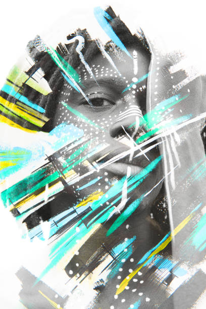 istock Paintography. African man with traditional style face paint dissolving behind colorful watercolor strokes 882397444