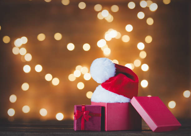 istock Christmas gift box and Santa Claus hat 882404990