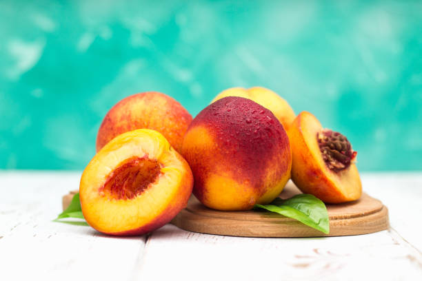 istock a lot of fresh peaches on a white table. 882405176