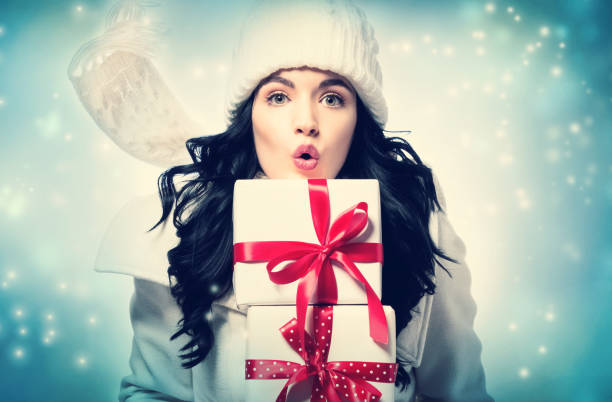 istock Young woman holding a Christmas gift 882405818