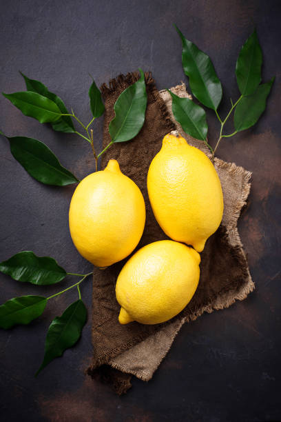 istock Fresh juicy lemons on rusty background 882411766