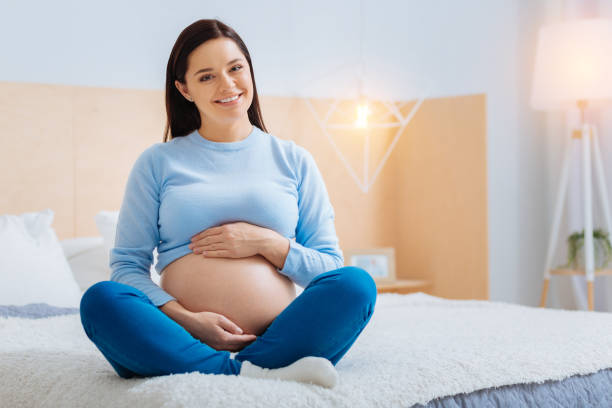 istock Cheerful female person expecting her baby 882414754