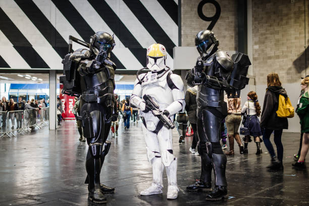 Cosplayers dressed as characters from Star Wars in Mandalorian armour at Birmingham MCM Comic Con.