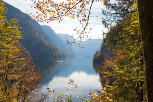 Königssee in Bavaria from the Malerwinkel in autumn with boat and reflection