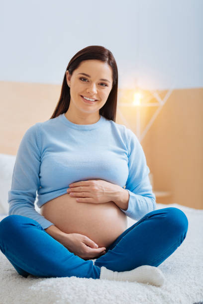 istock Positive delighted woman sitting at home 882414986
