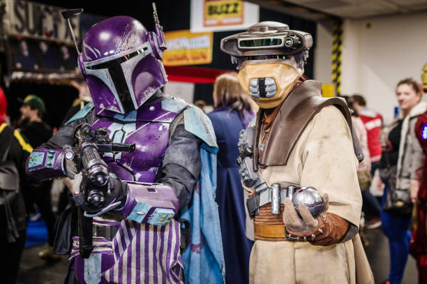 Cosplayer dressed as a Mandalorian and the bounty hunter Boushh from the Star Wars series at Birmingham MCM Comic Con.
