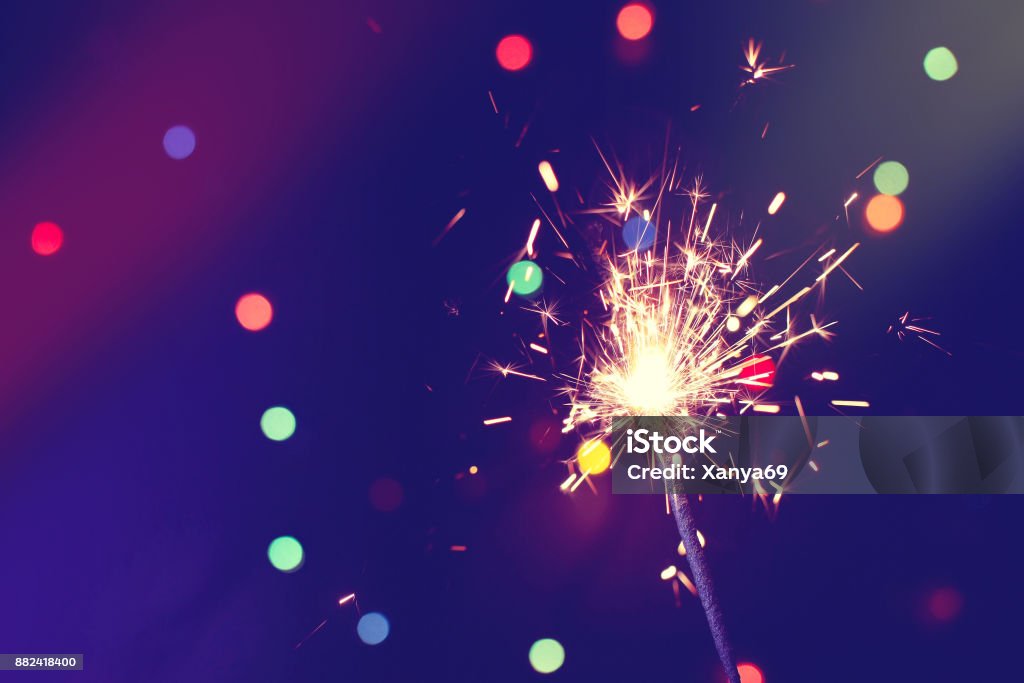 christmas, new year abstract background with sparkler christmas, new year abstract background with sparkler, colorful bokeh, holiday theme Sparkler - Firework Stock Photo