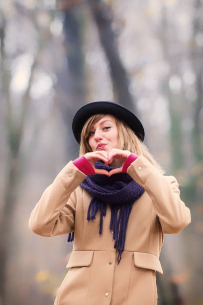istock Cute smiley girl holding a heart - shape. 882419356