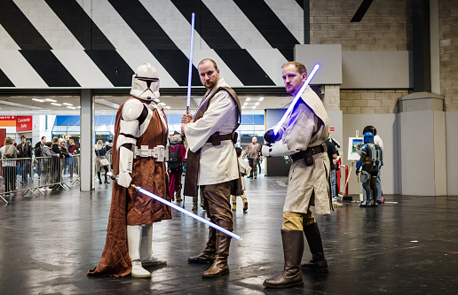 Cosplayers dressed as two Jedi knights and a Mandalorian knight at Birmingham MCM Comic Con.